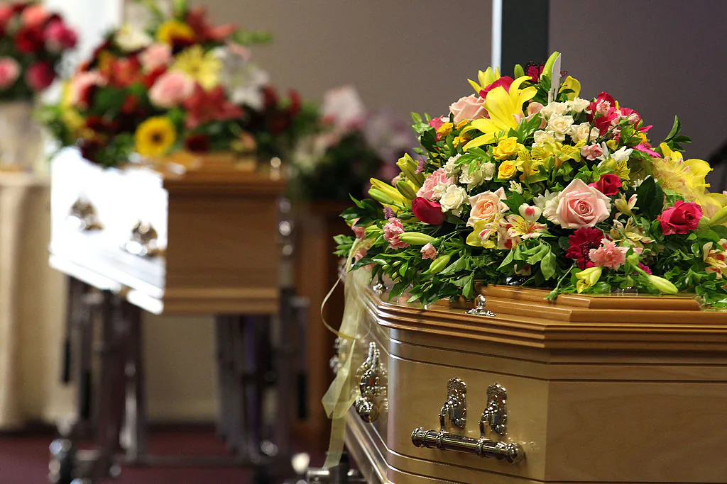Flowers cover the coffins at a funeral at the Gatton Baptist church in Queensland, Australia, on Jan. 20, 2014. (Tertius Pickard-Pool/Getty Images)