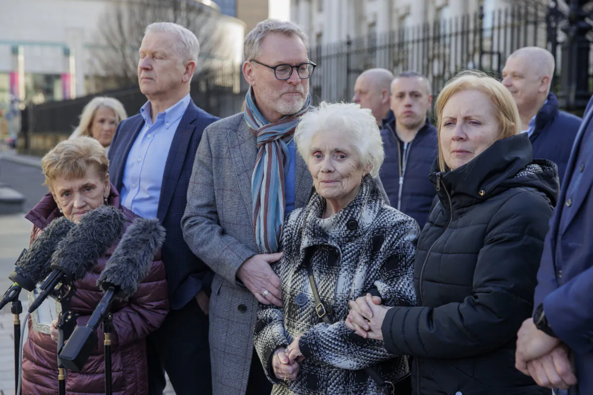 Marie Newton (L), widow of John Toland, and Mary Loughrey (C), widow of Jim Loughrey, with family members outside the Royal Courts Justice in Belfast on Feb. 26, 2024. (Liam McBurney/PA Wire)