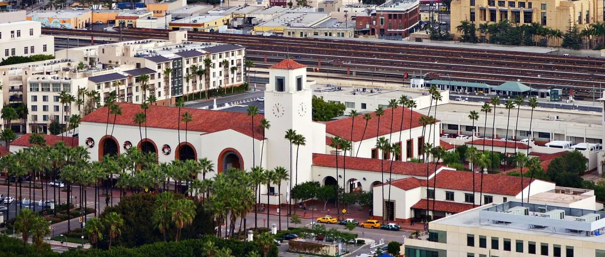 Union Station Los Angeles is set in a park-like setting. The color scheme of white walls and terracotta roof is complementary of the many other area structures in this part of Los Angeles. The San Gabriel Mountains are visible in the distance. (Basil Sofi/CC BY-SA 3.0)