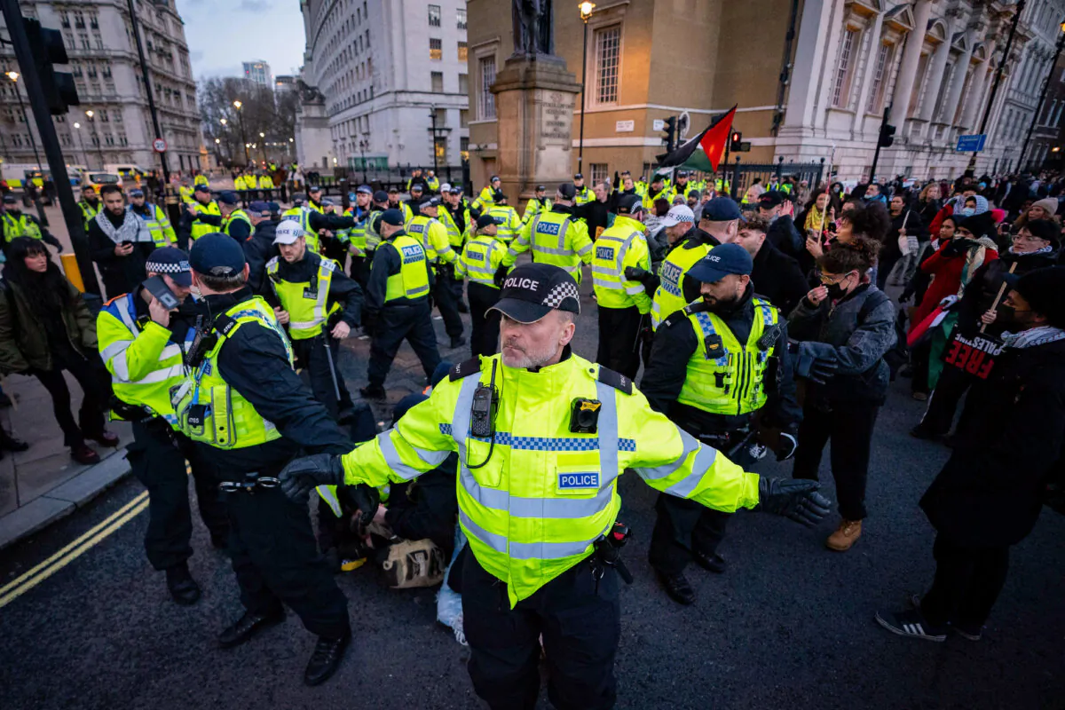 Police detain a person during a pro-Palestine march on Whitehall, organised by the Palestine Solidarity Campaign, in central London, on Dec. 9, 2023. (James Manning/PA Wire)