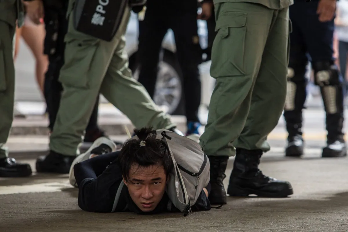 Riot police detain a man taking part in a rally against a new national security law, on the 23rd anniversary of the city's handover from the UK to China, in Hong Kong on July 1, 2020. (Dale De La Rey/AFP via Getty Images)