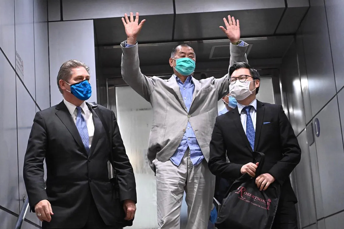 Jimmy Lai (C), founder of Next Media Group, was charged by the Hong Kong police with crimes such as "conspiracy to collude with foreign forces” and "conspiracy to publish seditious materials" under the Hong Kong National Security Law, on Aug. 12, 2020. He was released on bail after about 40 hours of detention and received an astounding ovation from the crowd on his way out of the police station. A week later, then-U.S. President Donald Trump praised him as a "brave man" in his answer to reporters. (Sung Pi-lung/The Epoch Times)