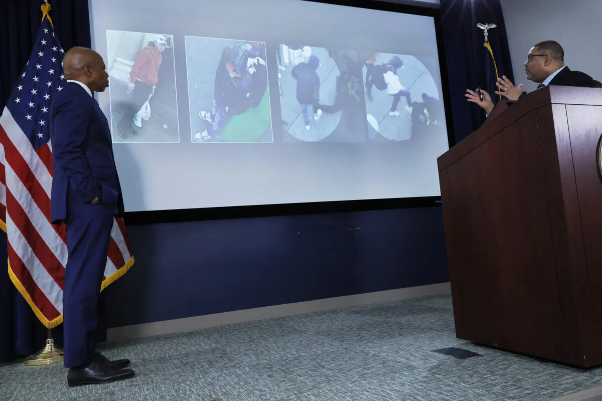 Mayor Eric Adams looks on Manhattan District Attorney Alvin Bragg displays images on a screen as he speaks during a press conference at the office of the District Attorneys in New York City on Feb. 8, 2024. (Michael M. Santiago/Getty Images)