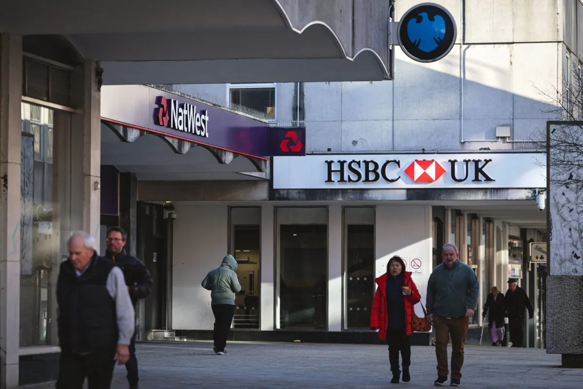 People walk pass a branches of HSBC, Natwest, and Barclays banks in Bracknell town centre, England, on Jan. 10, 2024. (Adrian Dennis/AFP via Getty Images)