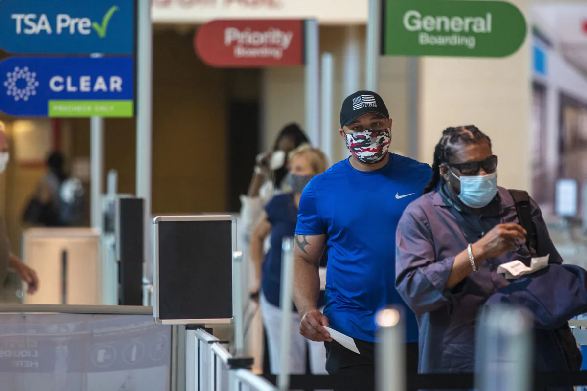 Masked passengers walk to the security checkpoint at Dallas Love Field airport in Dallas on July 26, 2020. (Lynda M. Gonzalez/Dallas Morning News/TNS)