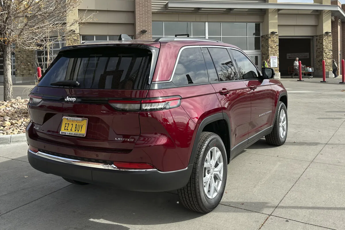 An unsold 2023 Jeep Grand Cherokee sports-utilty vehicle stands for inspection outside a Costco warehouse in Sheridan, Colo., on Oct. 26, 2023. (David Zalubowski/AP Photo)