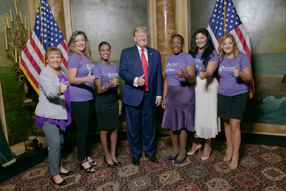 Former President Donald Trump poses with Moms for America staff members (L–R): Kimberly Fletcher, Maria Wagner, Aly Legge, Raquel Mitchell, Vanessa Faura, and Debbie Kraulidis, at Mar-a-Lago in Palm Beach, Fla., in November 2023. (Moms for America)