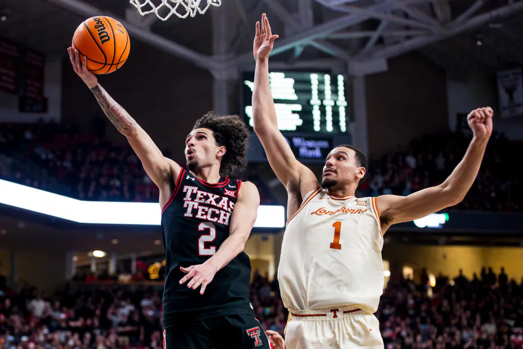 Pop Isaacs (2) of the Texas Tech Red Raiders shoots the ball against Dylan Disu (1) of the Texas Longhorns during the second half of the game at United Supermarkets Arena in Lubbock, Texas, on Feb. 27, 2024. (John E. Moore III/Getty Images)