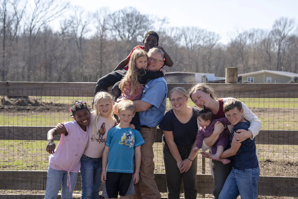 Coleman Boyd and 9 of his 13 children stand outside their home in Bolton, Miss., on Feb. 21, 2024. (Samira Bouaou/The Epoch Times)