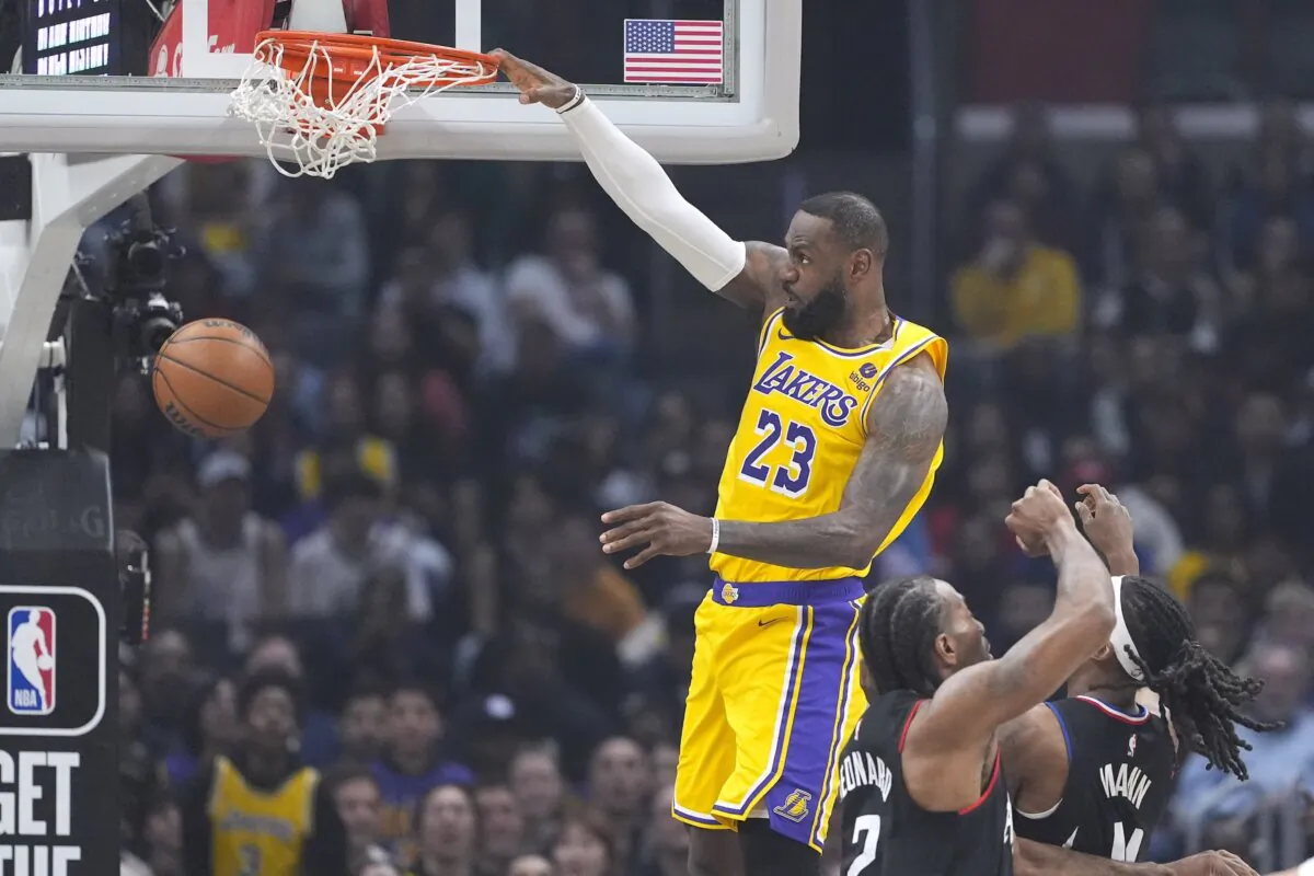 Los Angeles Lakers forward LeBron James (L) dunks as Los Angeles Clippers forward Kawhi Leonard, center, and guard Terance Mann defend during the first half of an NBA basketball game in Los Angeles on Feb. 28, 2024. (Mark J. Terrill/AP Photo)