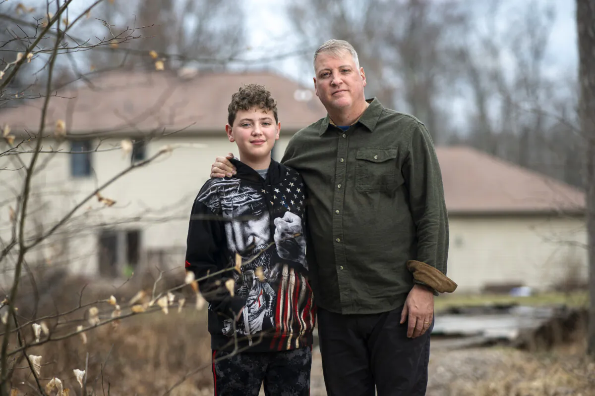Mark Houck with his son Mark Jr., in the backyard of their home in Kintnersville, Pa., on March 17, 2023. (Samira Bouaou/The Epoch Times)