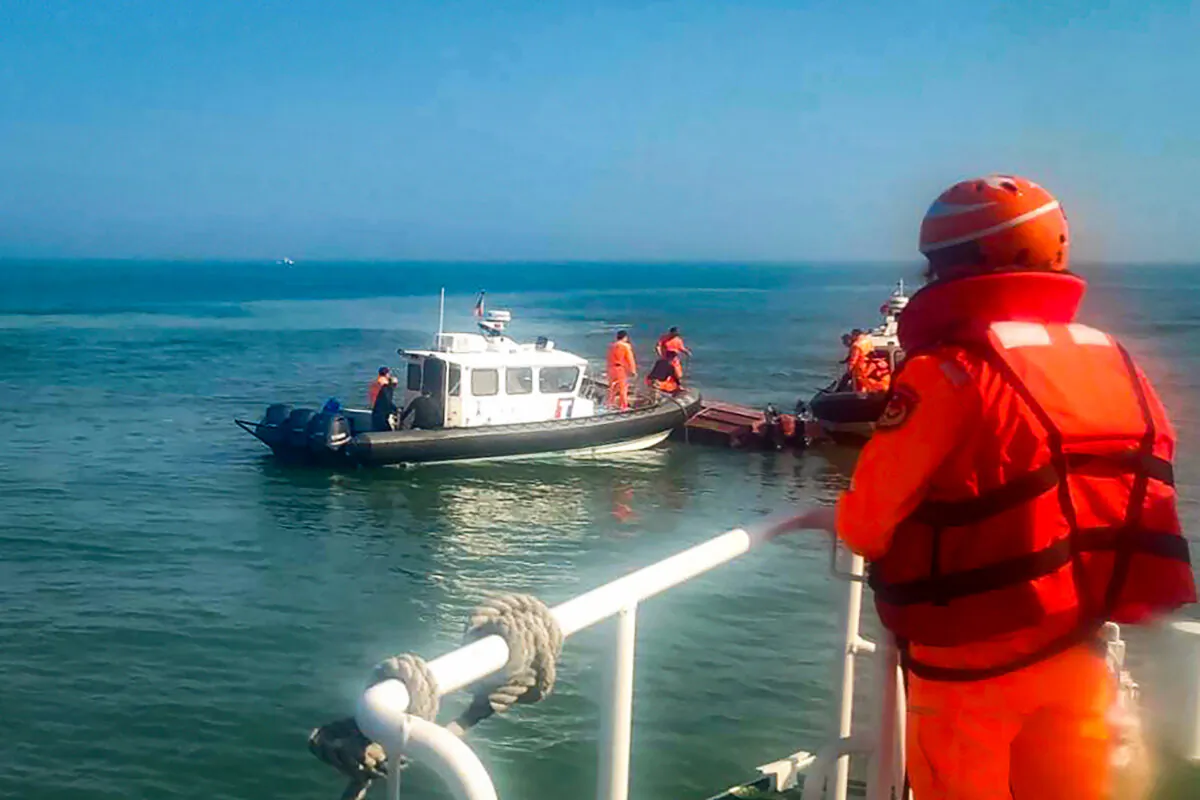 Taiwanese coast guards inspect a vessel that capsized during a chase off the coast of the Kinmen archipelago in Taiwan on Feb. 14, 2024. (Taiwan Coast Guard Administration via AP)
