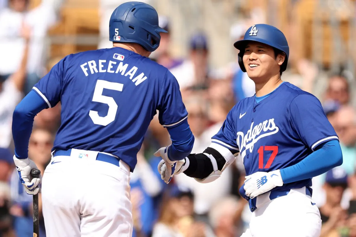 Shohei Ohtani (17) celebrates with Freddie Freeman (5) of the Los Angeles Dodgers after hitting a two-run home run in the fifth inning inning during a game against the Chicago White Sox in Glendale, Ariz., on Feb. 27, 2024. (Christian Petersen/Getty Images)