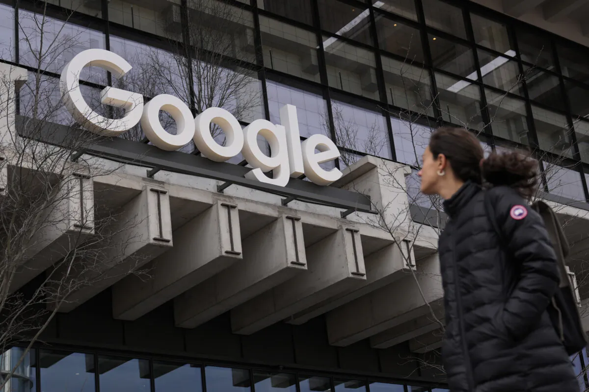 A woman walks past the Google building in New York on Feb. 26, 2024. (Seth Wenig/AP Photo)