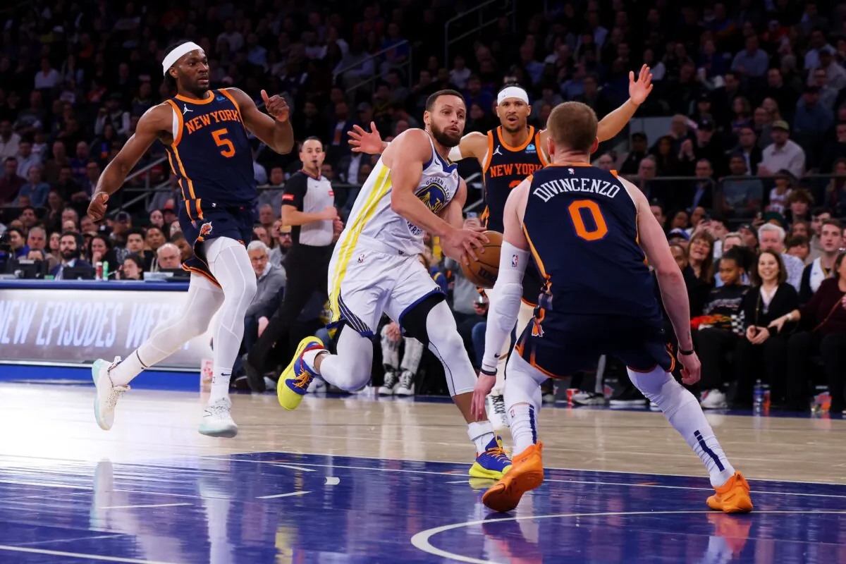 Stephen Curry (30) of the Golden State Warriors drives to the basket against Donte DiVincenzo (0) of the New York Knicks at Madison Square Garden in New York City on Feb. 29, 2024. (Mike Stobe/Getty Images)