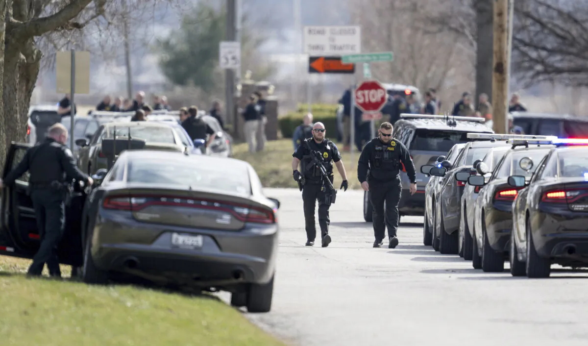 Law enforcement officials and medical personnel work the scene of an officer involved shooting near the intersection of Elsea Smith Road and Budschu Road in Independence, Mo., on Feb. 29, 2024. (Nick Wagner/The Kansas City Star via AP)