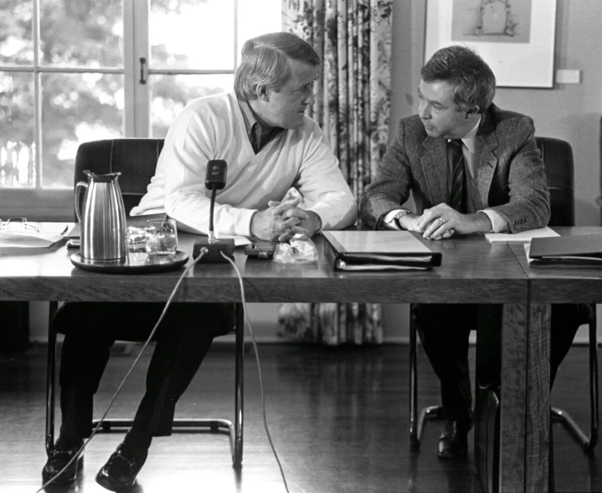 Prime Minister Brian Mulroney talks with External Affairs Minister Joe Clark before the start of a cabinet meeting at Meech Lake, Que., on Oct. 23, 1984. (CP PICTURE ARCHIVE/Andy Clark)