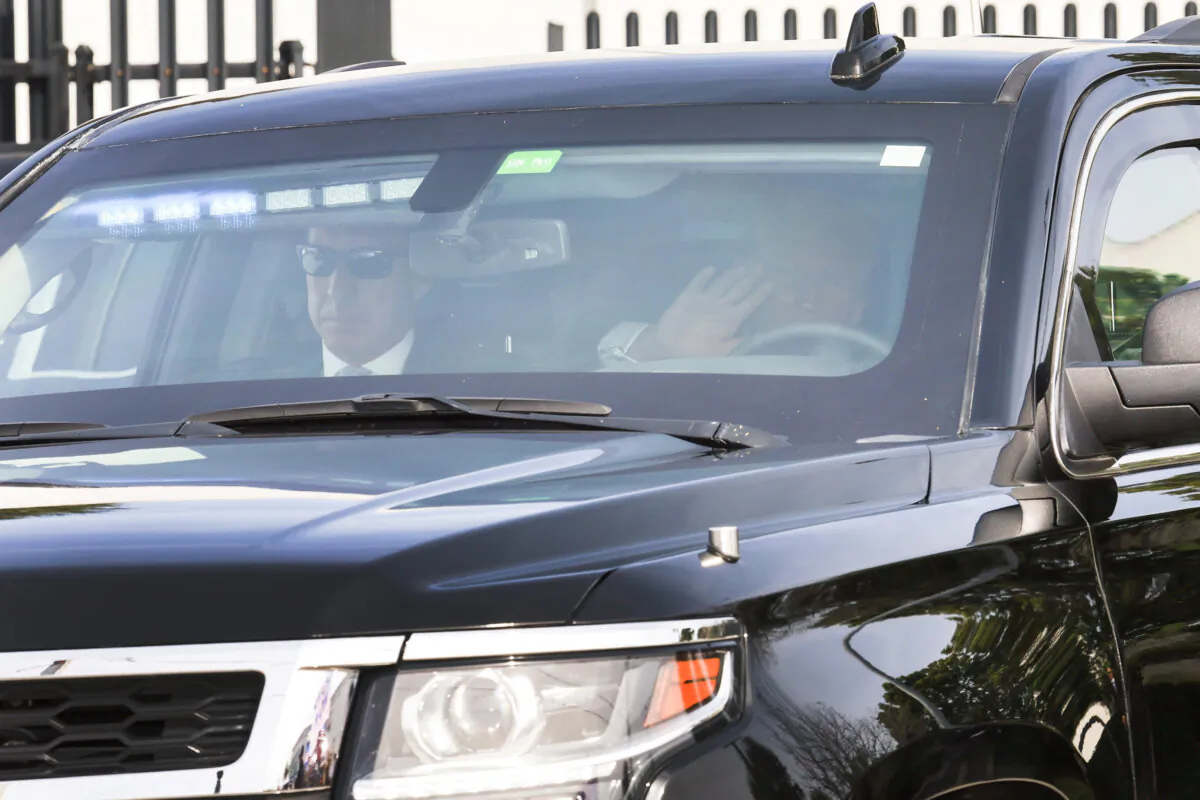 Former President Donald Trump waves to supporters as he is driven from the Alto Lee Adams Sr. U.S. Courthouse on March 1, 2024 in Fort Pierce, Florida. (Joe Raedle/Getty Images)