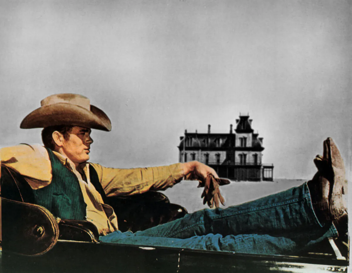A movie poster for the 1956 film, "Giant," featuring James Dean in cowboy denim. (Photo 12/Alamy Stock Photo)