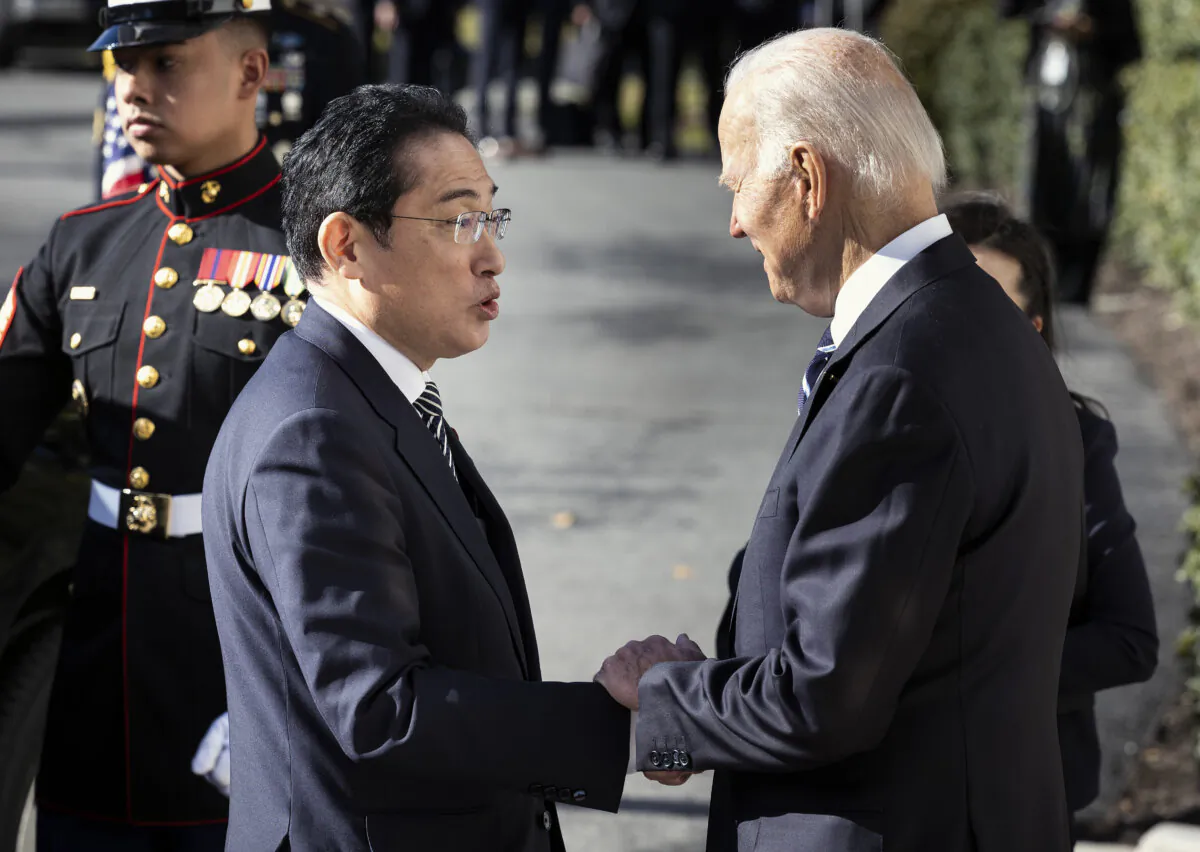 U.S. President Joe Biden (R) greets Japanese Prime Minister Kishida Fumio as he arrives at the White House in Washington on Jan. 13, 2023. Fumio is meeting with Biden to reaffirm the U.S.-Japan strategic relationship in the Indo-Pacific as military tensions rise in the region. (Kevin Dietsch/Getty Images)