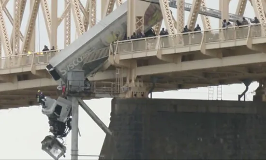 Truck Driver Pulled to Safety After Crash Leaves Vehicle Dangling Over Bridge Across Ohio River