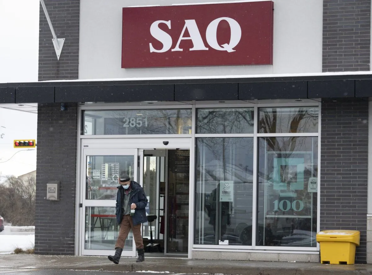 A customer leaves an SAQ outlet, Jan. 6, 2022 in Deux-Montagnes, Quebec. (The Canadian Press/Ryan Remiorz)