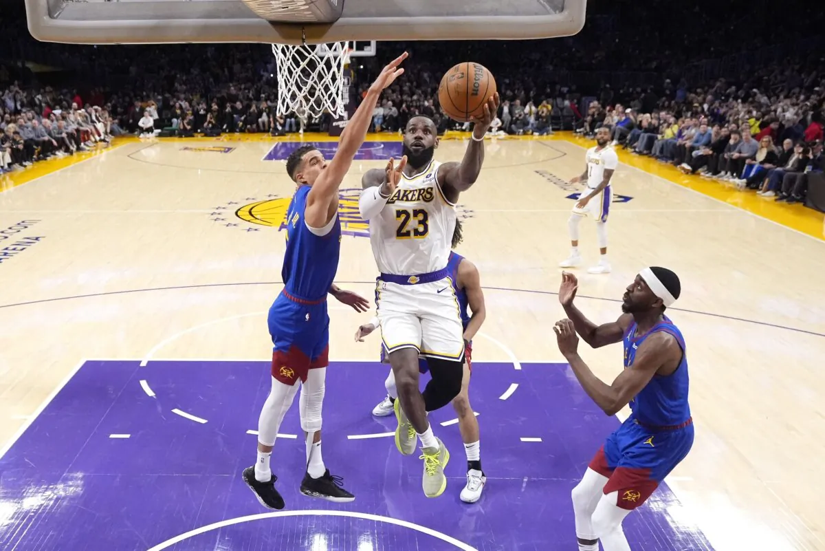 Los Angeles Lakers forward LeBron James (23) scores as Denver Nuggets forward Michael Porter Jr., defends during the first half of an NBA basketball game in Los Angeles on March 2, 2024. (Mark J. Terrill/AP Photo)