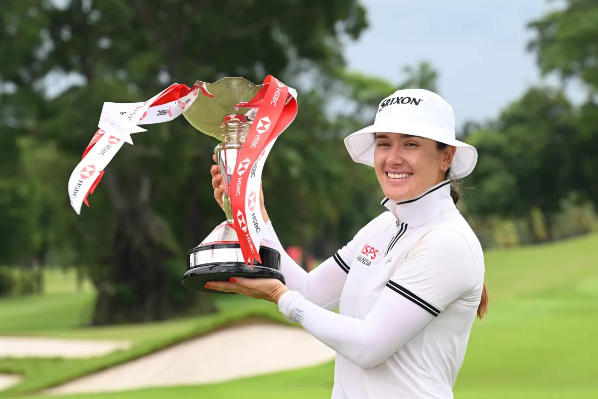Hannah Green of Australia poses with the trophy in celebration of victory on the 18th green on Day Four of the HSBC Women's World Championship in Singapore on March 3, 2024. (Kinnaird/Getty Images)