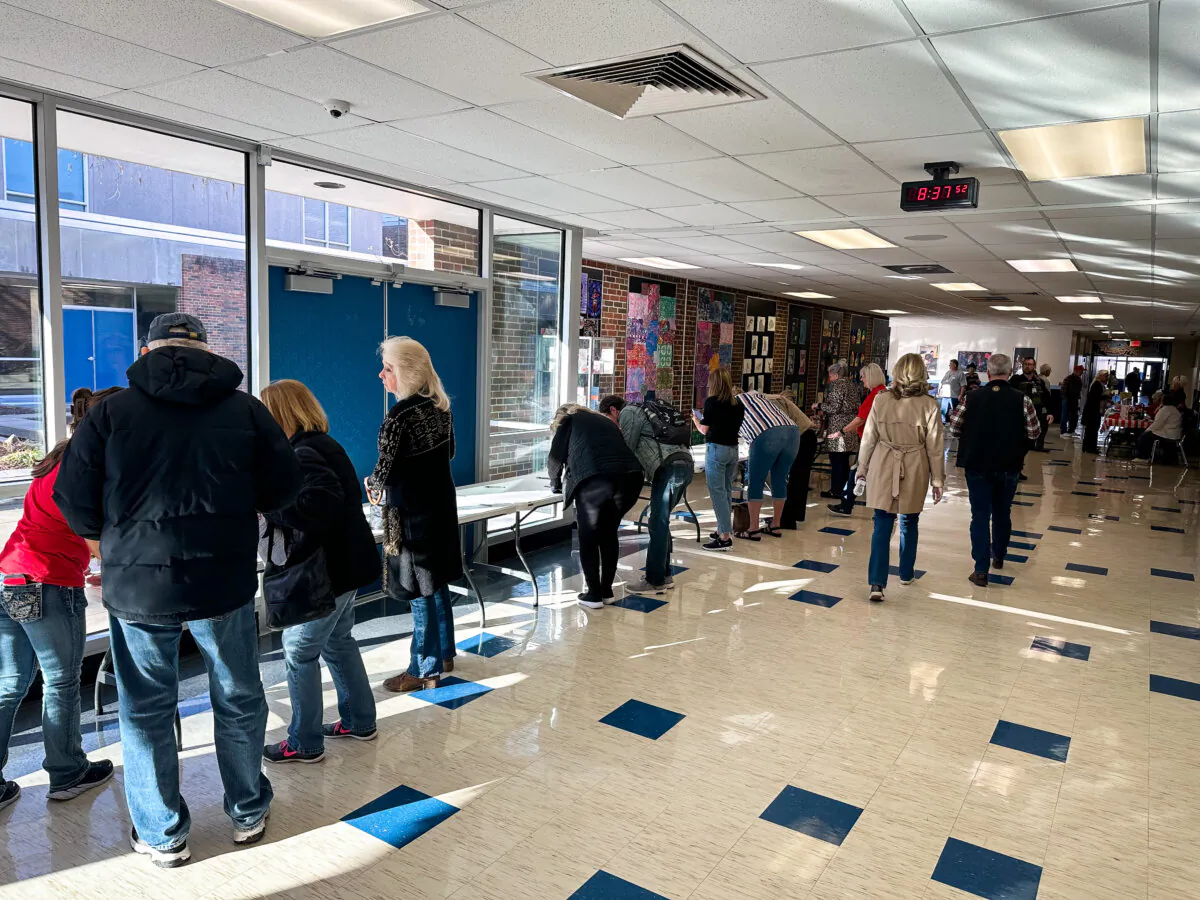 Clay County, Missouri, caucusgoers sign a pledge stating that they are a "strong and faithful Republican" ahead of the county's caucus. The caucus is one of more than 115 that will take place on the morning of Saturday, March 2, 2024. (Austin Alonzo/The Epoch Times)