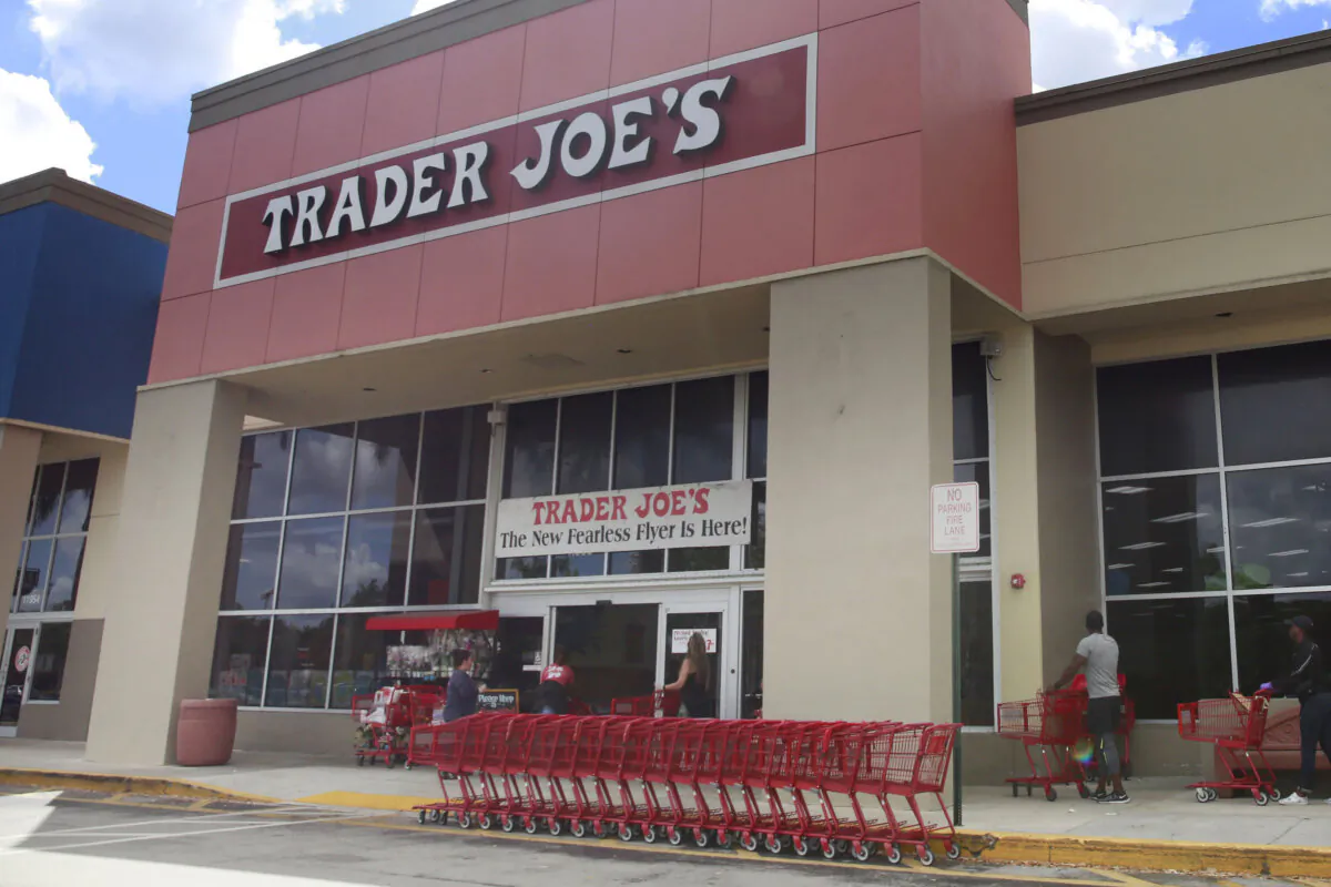 People stand in line waiting to enter Trader Joe's to buy groceries in Pembroke Pines, Fla., on March 24, 2020. (Brynn Anderson/AP Photo)
