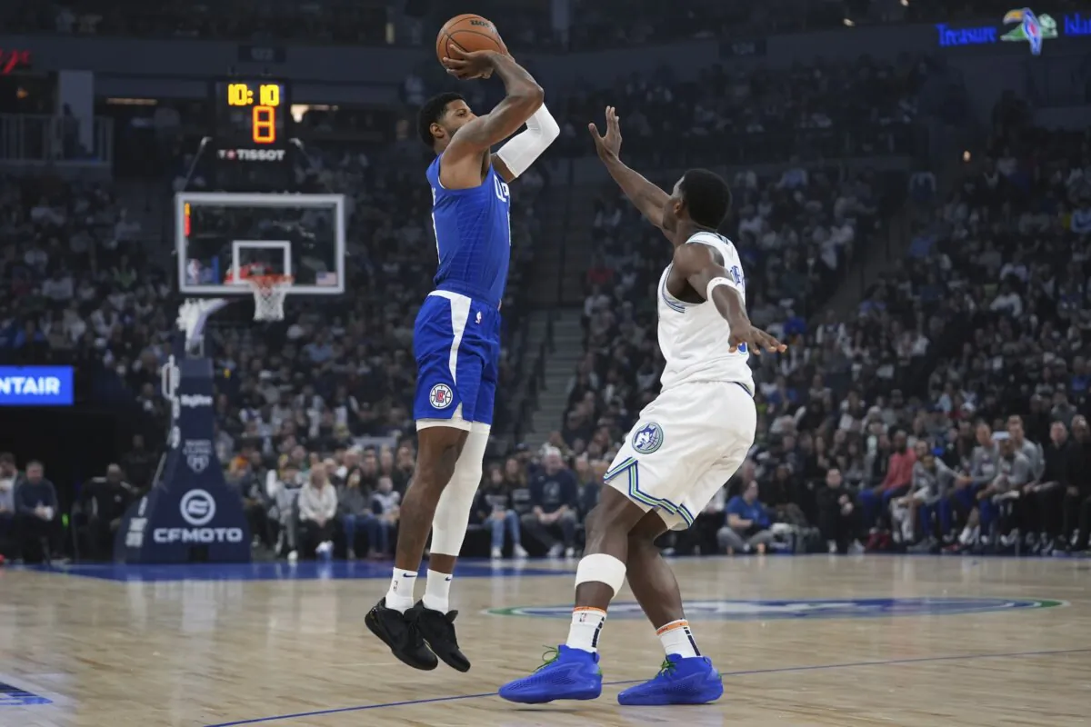 Los Angeles Clippers forward Paul George (L) shoots over Minnesota Timberwolves guard Anthony Edwards during the first half of an NBA basketball game in Minneapolis on March 3, 2024. (Abbie Parr/AP Photo)