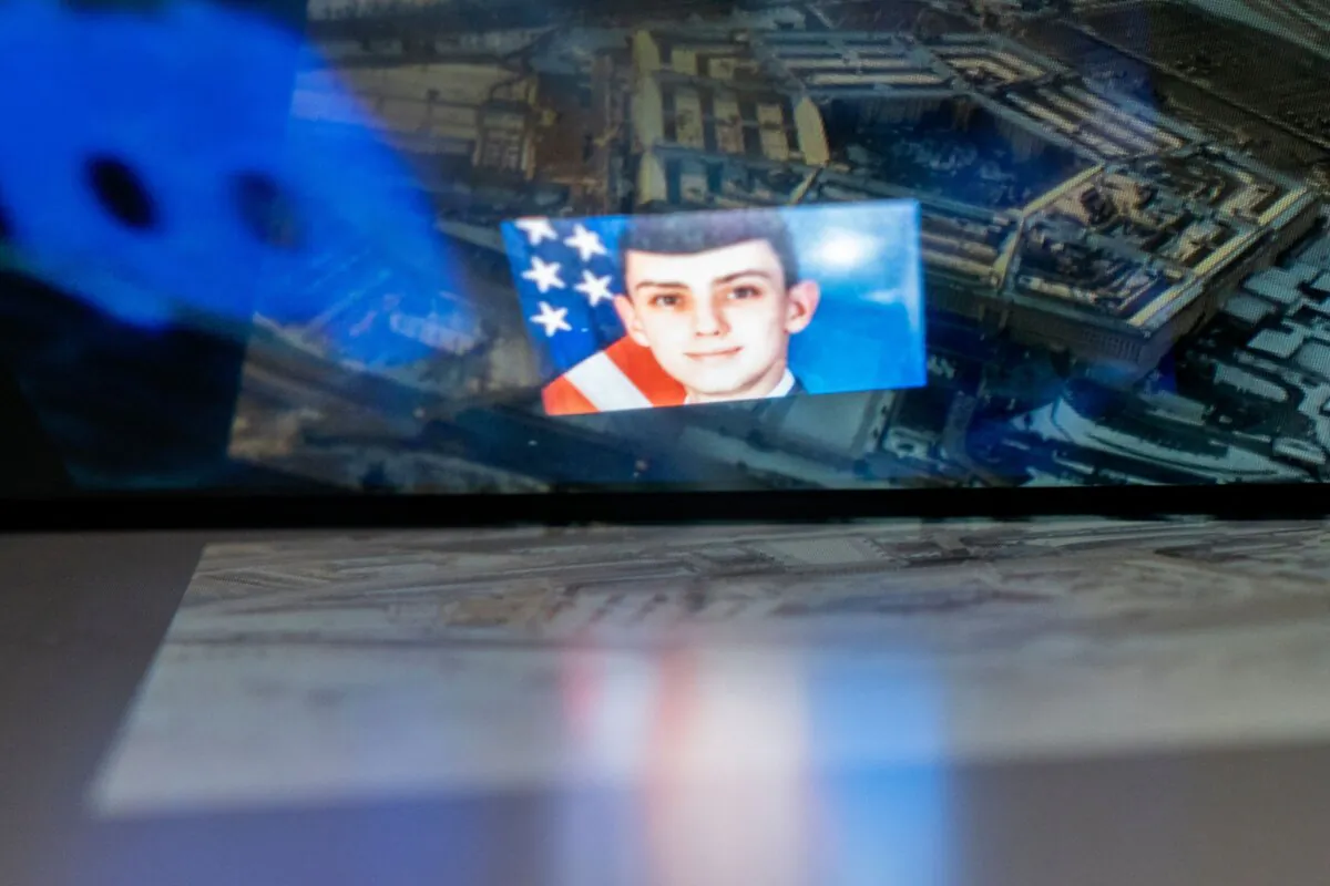 The Discord logo and Massachusetts Air National Guardsman Jack Teixeira, reflected in an image of the Pentagon in Washington on April 13, 2023. (Stefani Reynolds/AFP via Getty Images)