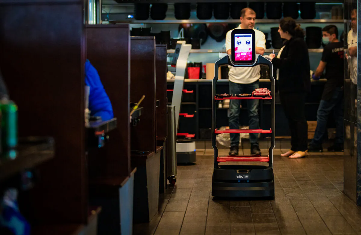 A robot delivers food orders at I Can Korean Barbeque in Tustin, Calif., on Feb. 14, 2023. (John Fredricks/The Epoch Times)