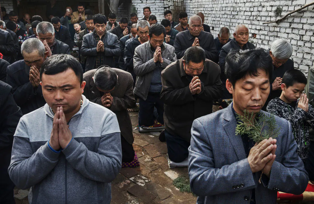 Chinese Catholic worshippers kneel and pray during Palm Sunday Mass during the Easter Holy Week at an "underground" or "unofficial" church near Shijiazhuang, Hebei Province, China, on April 9, 2017. China, an officially atheist country, places a number of restrictions on Christians, allowing legal practice of the faith only at state-approved churches. (Kevin Frayer/Getty Images)