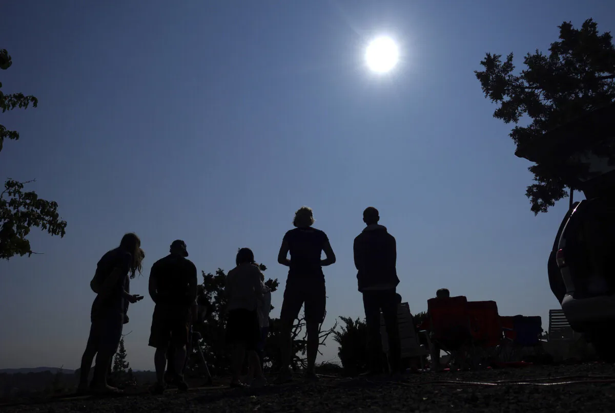 People gather near Redmond, Ore., to view the sun as it nears a total eclipse by the moon, on Aug. 21, 2017. (Ted S. Warren/AP Photo)