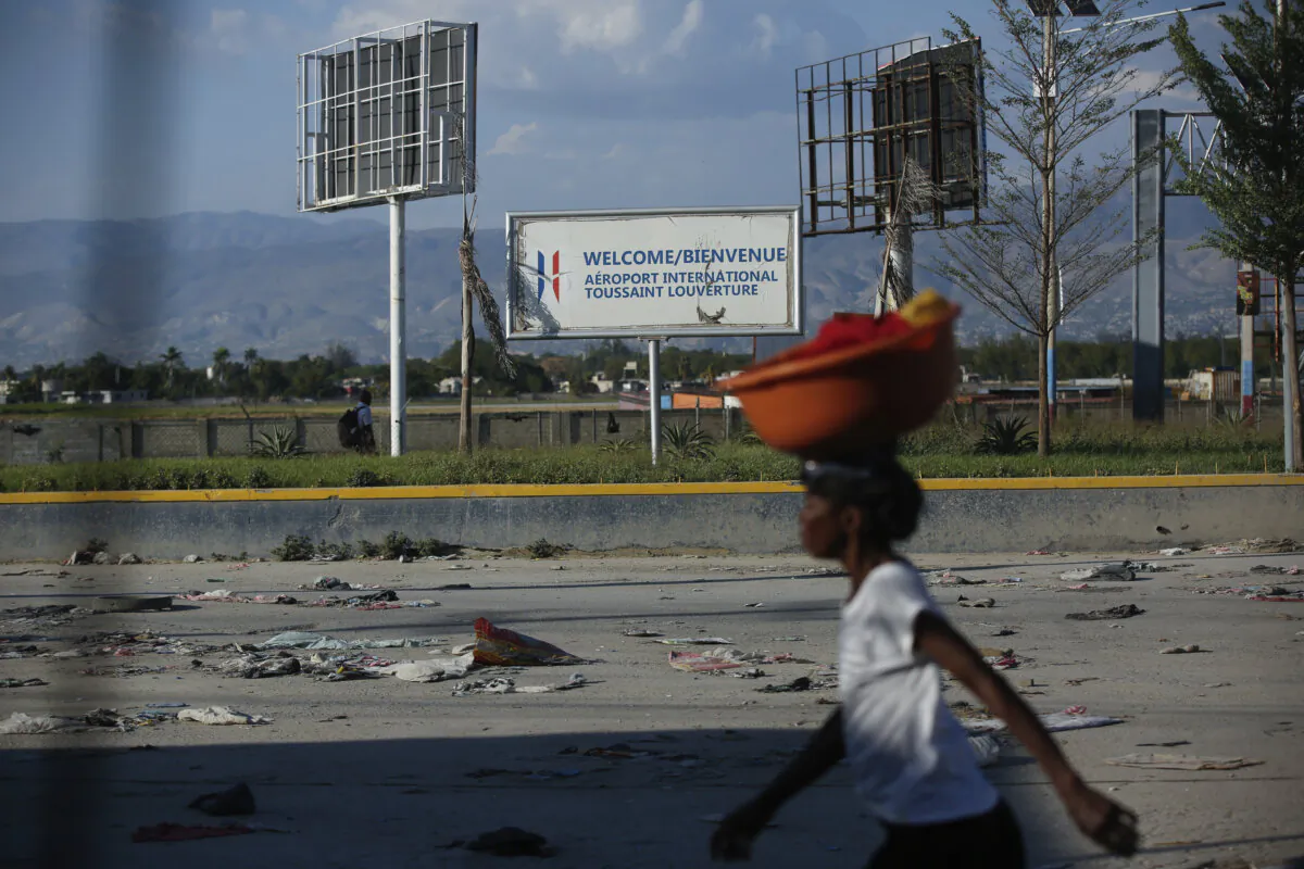A pedestrian walks past the international airport in Port-au-Prince, Haiti, on March 4, 2024. (Odelyn Joseph/AP Photo)