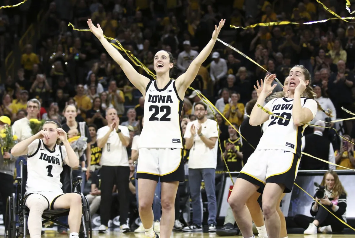 Guard Caitlin Clark (22) and guard Kate Martin (20) of the Iowa Hawkeyes celebrates in the confetti after senior day festivities after the match-up against the Ohio State Buckeyes in Iowa City, Iowa on March 3, 2024. (Matthew Holst/Getty Images)