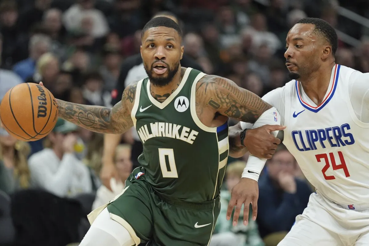 Milwaukee Bucks' Damian Lillard tries to get past Los Angeles Clippers' Norman Powell during the first half of an NBA basketball game in Milwaukee on March 4, 2024. (AP Photo/Morry Gash)