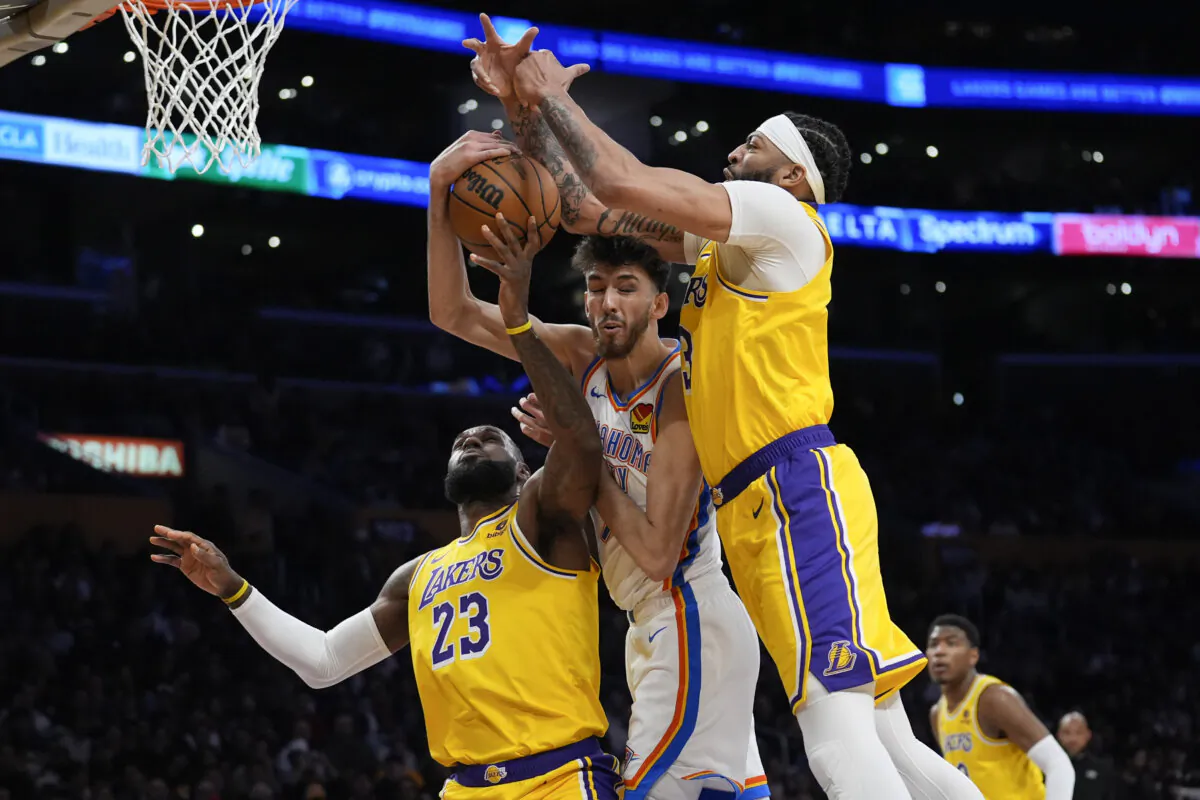 Oklahoma City Thunder forward Chet Holmgren, center, works for a rebound between Los Angeles Lakers forward LeBron James (23) and forward Anthony Davis during the first half of an NBA basketball game in Los Angeles on March 4, 2024. (Marcio Jose Sanchez/ AP Photo)