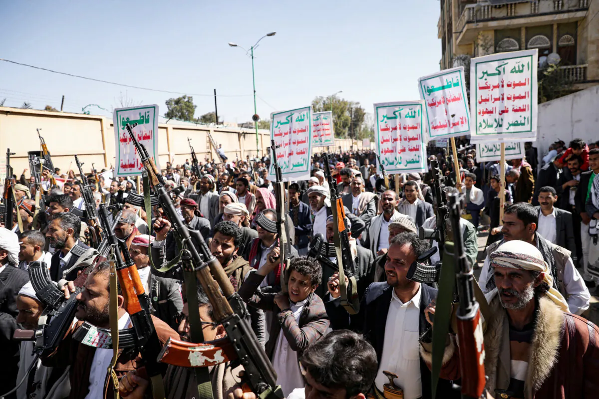 Houthi supporters hold up their weapons during a demonstration against the United States decision to designate the Houthis as a foreign terrorist organization, in Sanaa, Yemen, on Jan. 20, 2021. (Khaled Abdullah/Reuters)