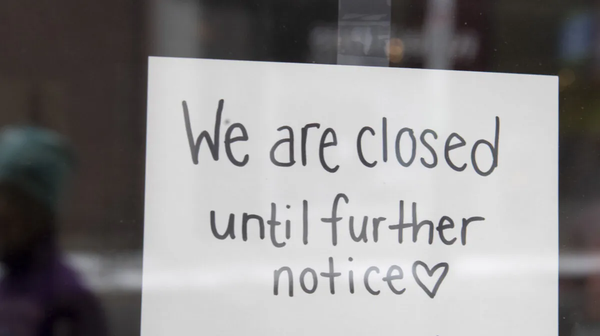 A sign on a shop window indicates the store is closed in Ottawa, on Mar. 23, 2020. (The Canadian Press/Adrian Wyld)