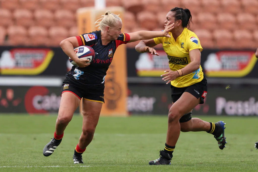 Grace Steinmetz of the Chiefs Manawa looks to fend off the tackled during the round one Super Rugby Aupiki match between Chiefs Manawa and Hurricanes Poua at FMG Stadium Waikato in Hamilton, New Zealand on March 2, 2024. (Michael Bradley/Getty Images)