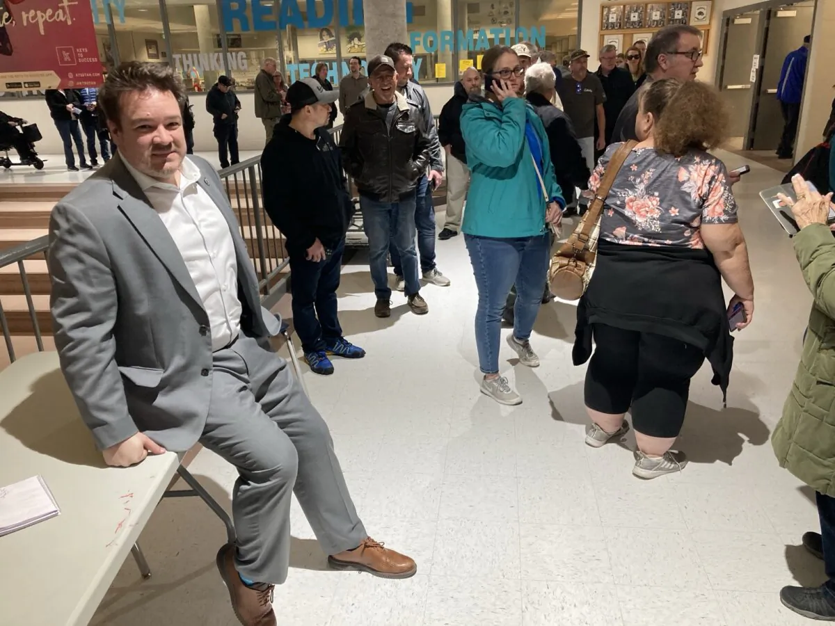 Utah state Rep. Matt MacPherson pauses from telling voters to be patient while waiting for a computer glitch to be resolved during Utah’s Super Tuesday Republican caucuses at Hunter High School in West Valley City, on March 5, 2024. (John Haughey/The Epoch Times) 