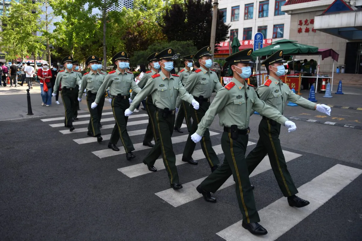Paramilitary police officers patrol in a shopping area on the closing day of the Chinese People's Political Consultative Conference in Beijing on May 27, 2020. (Greg Baker/AFP via Getty Images)