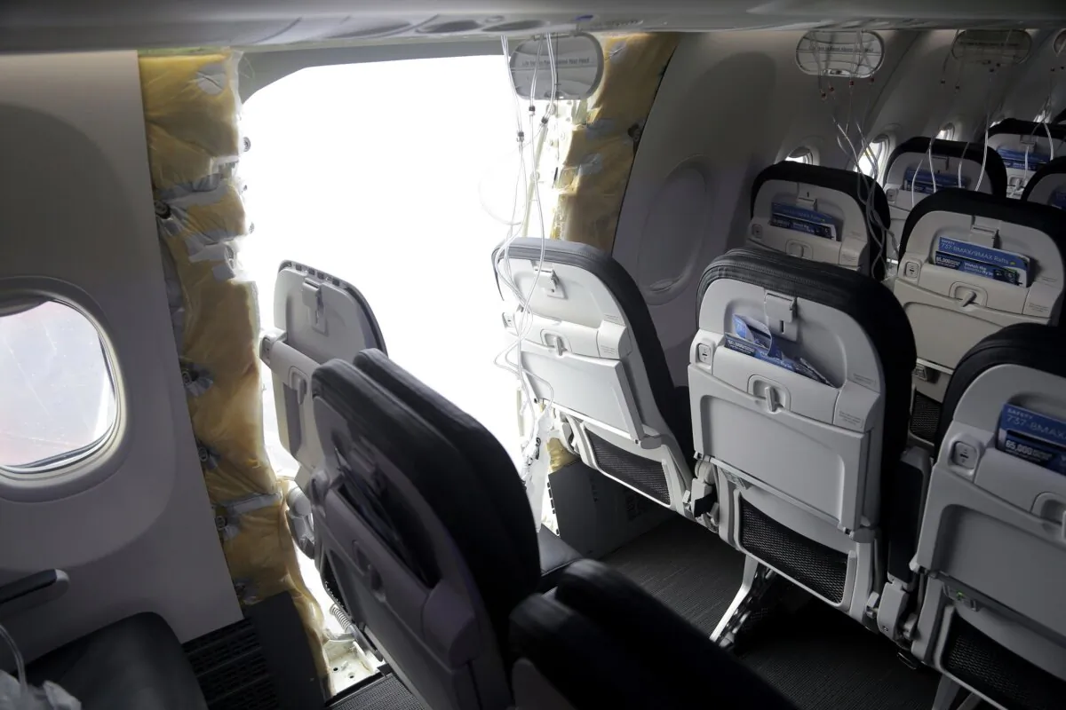 A gaping hole where the paneled-over door had been at the fuselage plug area of Alaska Airlines Flight 1282 in Portland on Jan. 7, 2024. (National Transportation Safety Board via AP)