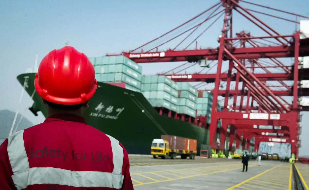 In this file photo, a worker watches operations at the container off-loading terminal in the Jawaharlal Nehru Port Trust (JNPT) premises in Mumbai, India. (Indranil Mukherjee/AFP via Getty Images)