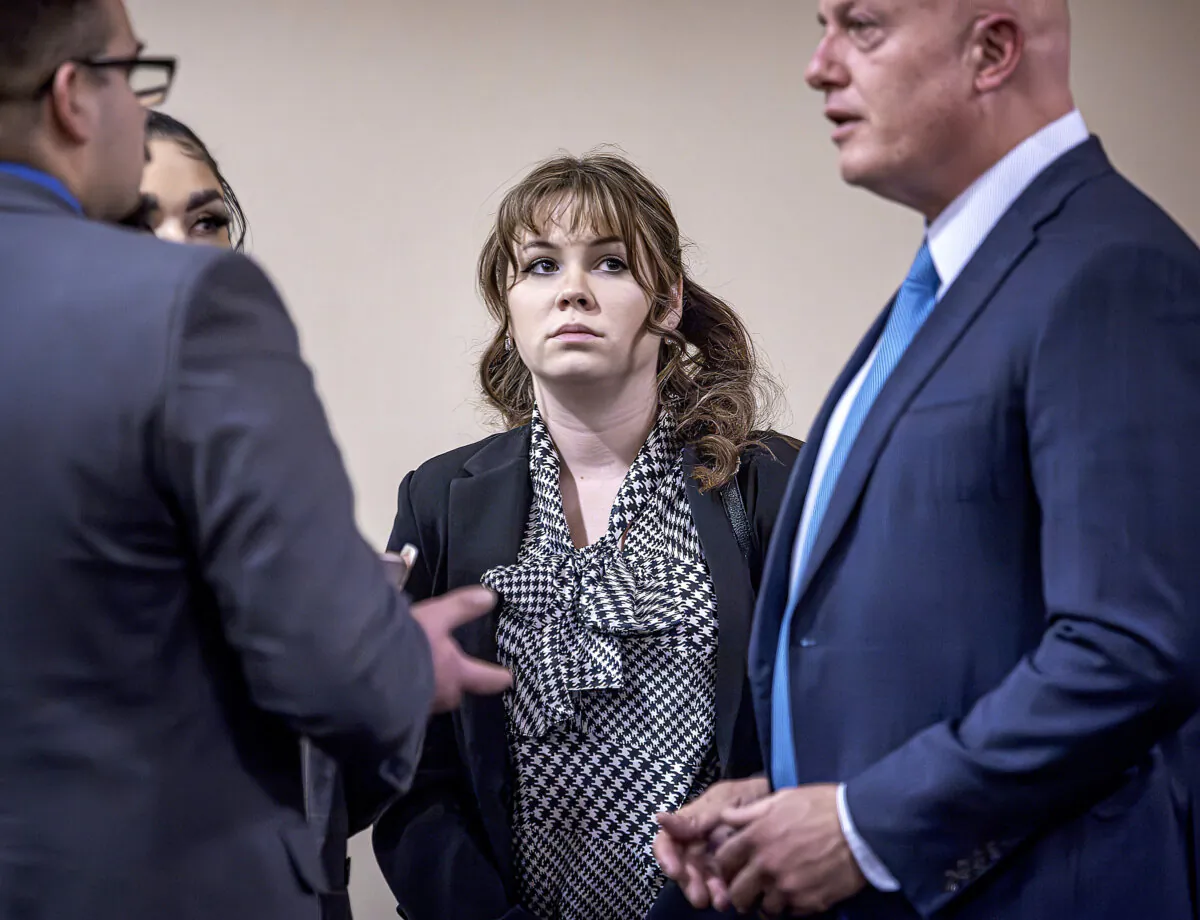 "Rust" movie armorer Hannah Gutierrez-Reed (C) talks with her attorney Jason Bowles (R) and her defense team during her involuntary manslaughter trial at the First Judicial District Courthouse in Santa Fe, N.M., on March 5, 2024. (Jim Weber/Pool/Santa Fe New Mexican via AP)