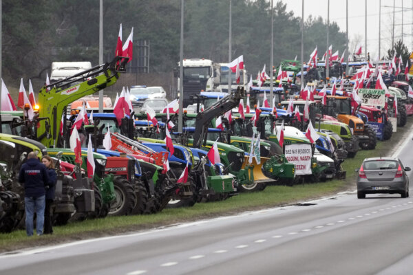 Polish farmers block a major road with tractors during a protest in Lomianki, near Warsaw, Poland, on Wednesday, March 6, 2024. The protest ratchets up pressure on the government as they demand the Poland-Ukraine border closed to food imports and demand changes to European Union climate and agricultural policies. (AP Photo/Czarek Sokolowski)