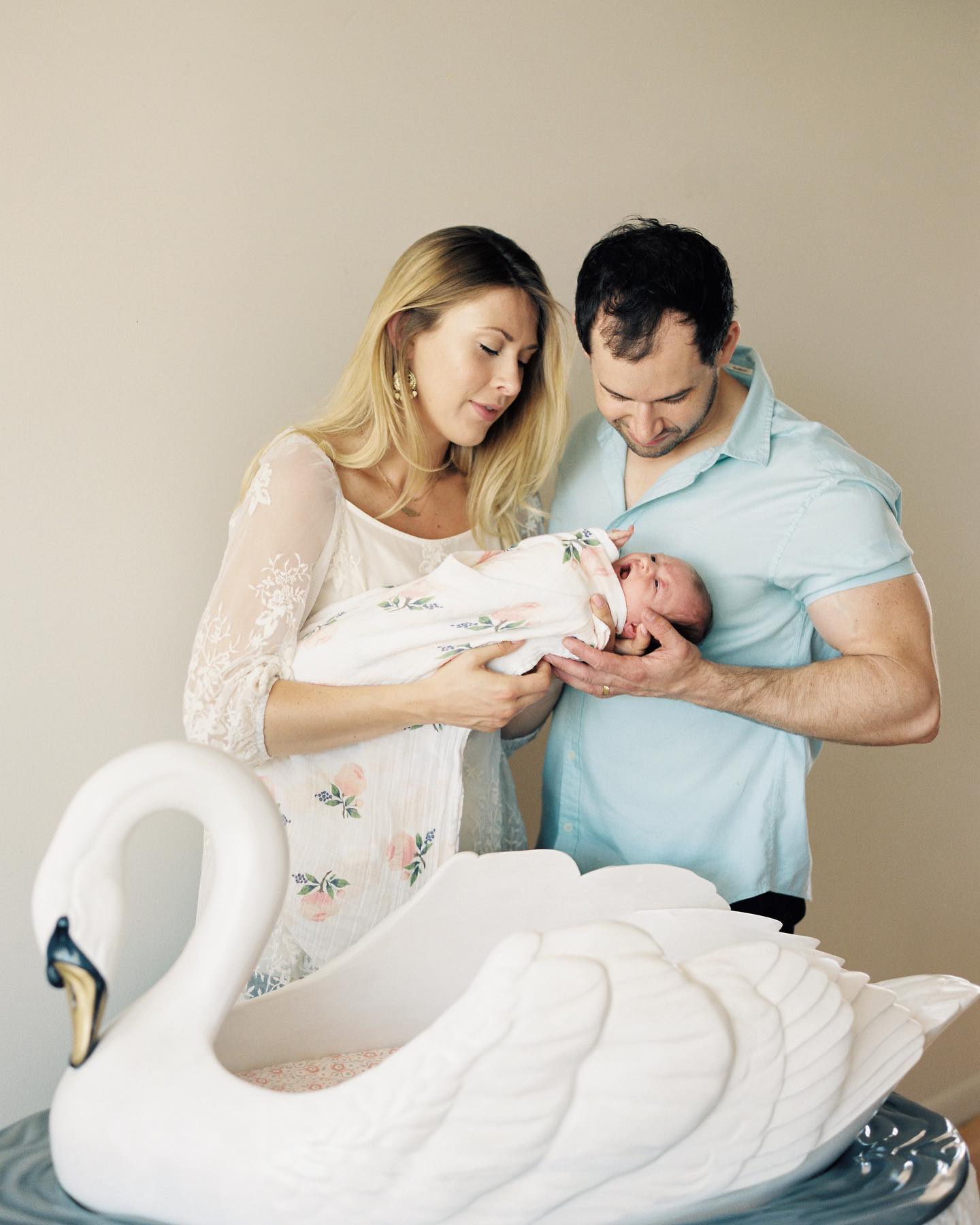 Hannah and Jake holding their first baby, Emma.