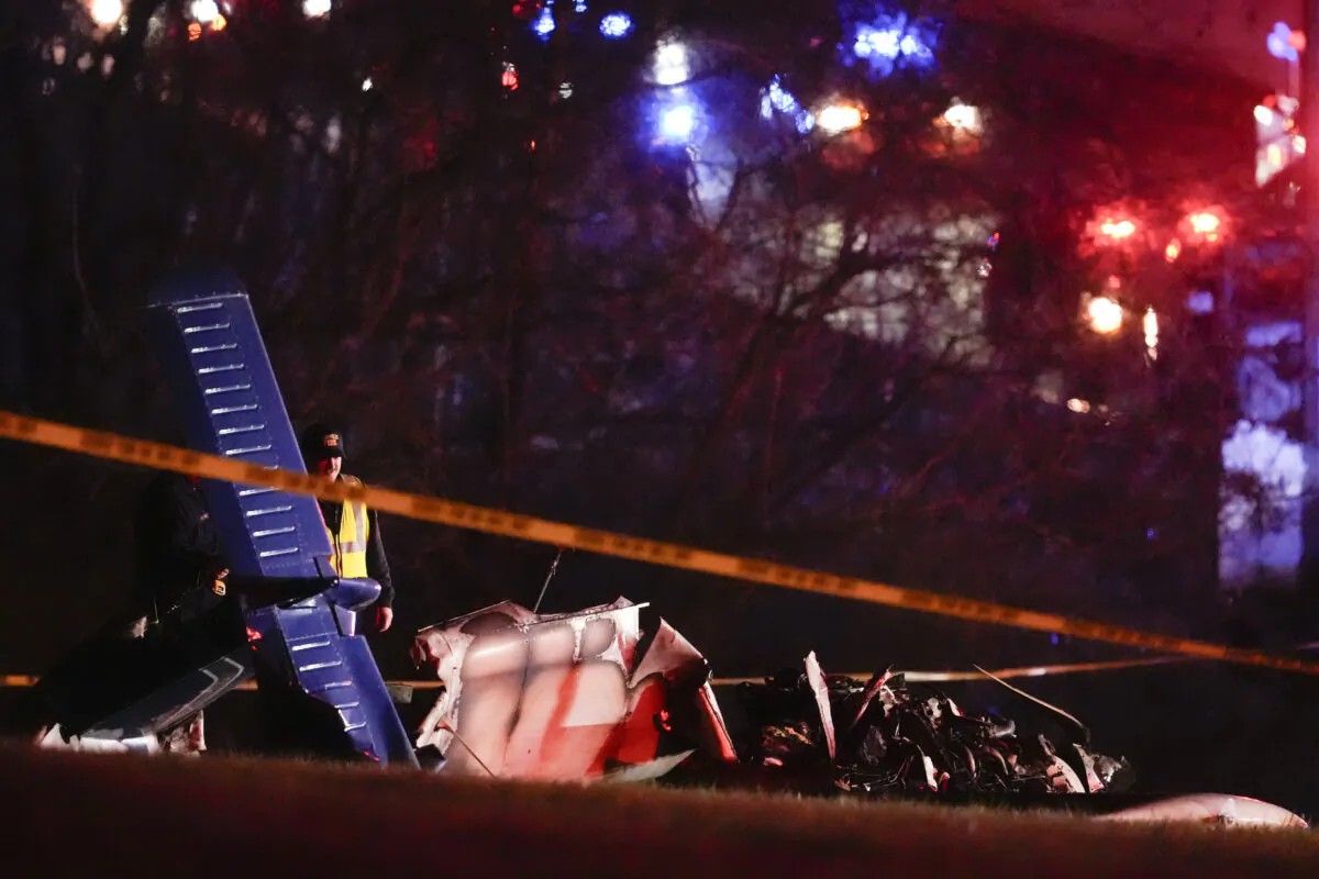 Emergency officials work the scene of a fatal small plane crash alongside Interstate 40 near mile marker 202, in Nashville, Tenn. on March 4, 2024. (The Canadian Press/AP George Walker IV)